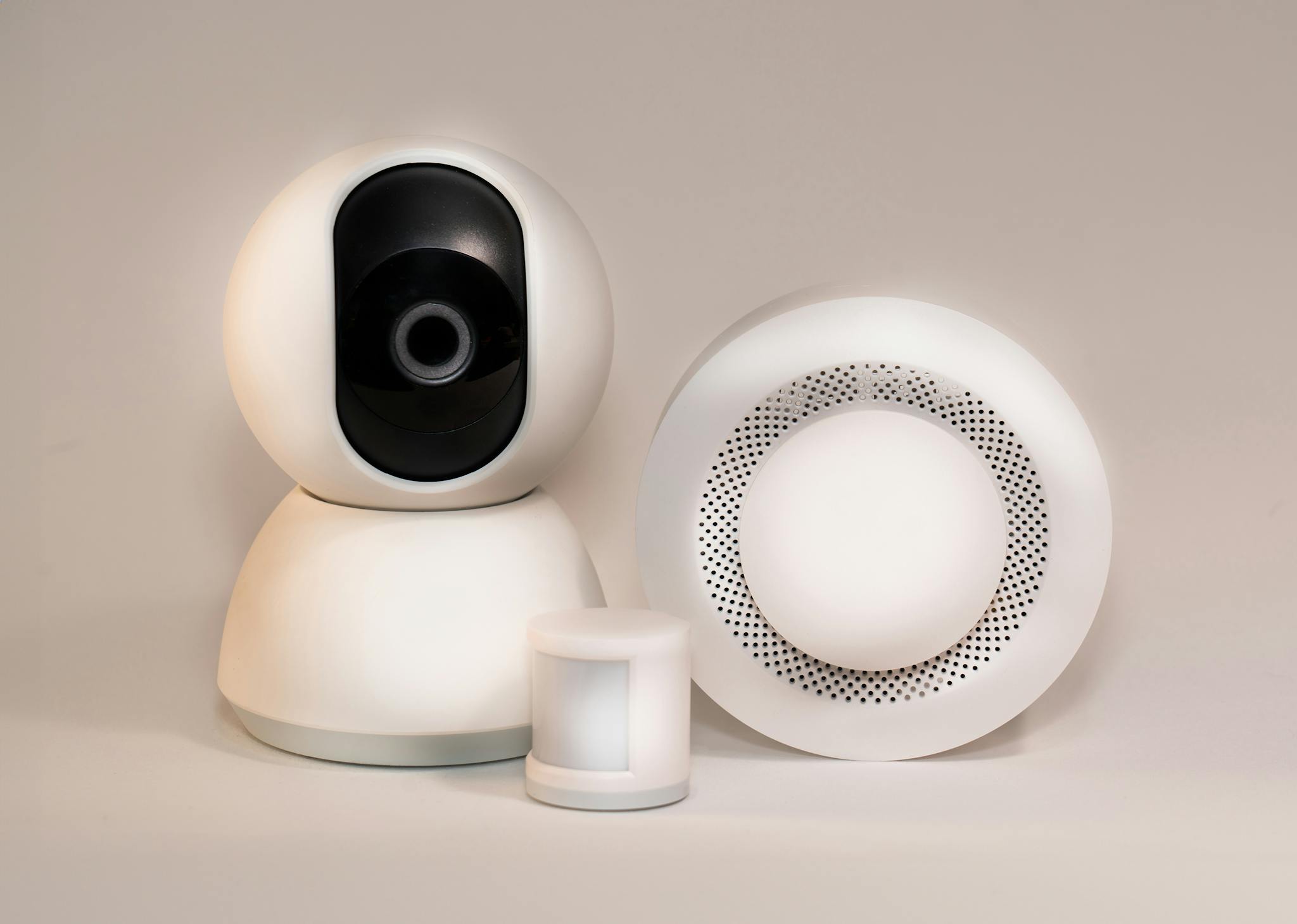 A collection of modern smart home security devices featuring cameras and sensors.
